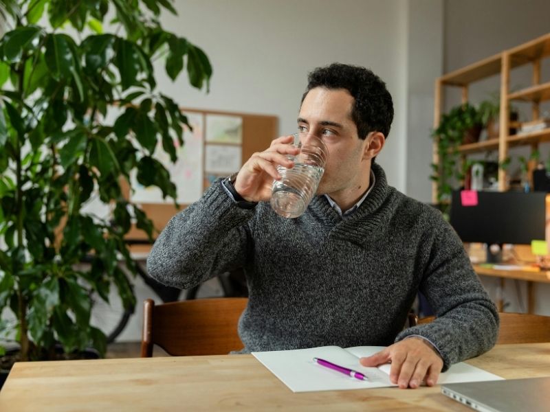 Rich person drinking water after waking up morning hydration habit